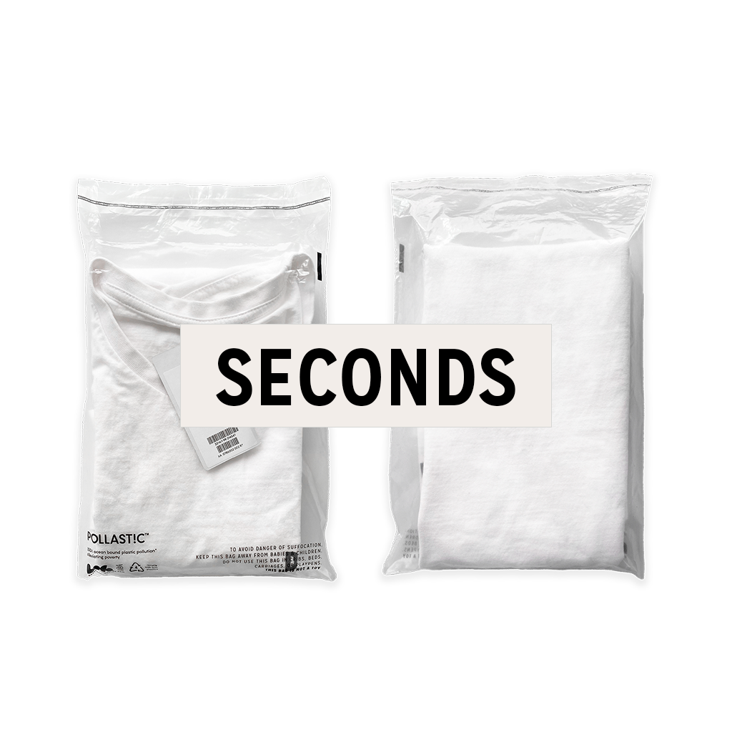 Front and back of a transparent Better Packaging POLLAST!C poly garment bag, containing a white tee shirt with a graphic label "Seconds" overlaid on a transparent background