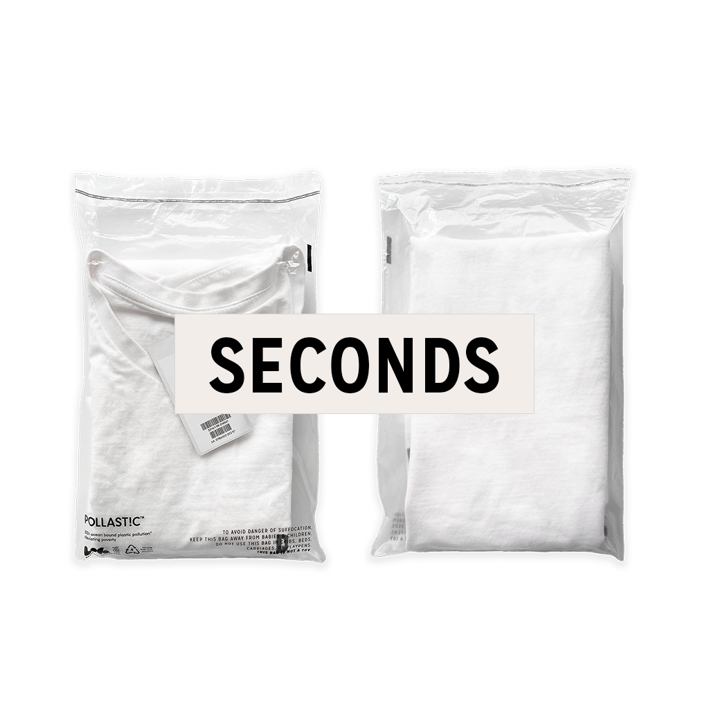 Front and back of a transparent Better Packaging POLLAST!C poly garment bag, containing a white tee shirt with a graphic label &quot;Seconds&quot; overlaid on a transparent background